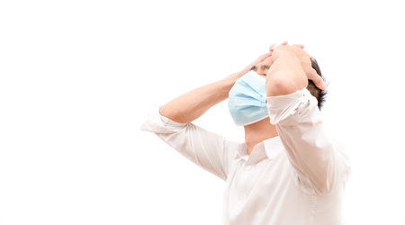 The image of a young Asian man wearing a mask to prevent germs, toxic fumes, and dust. Prevention of bacterial infection in the air around in the white background.の写真素材