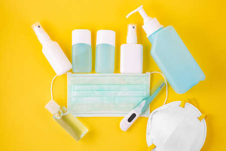 Doctor Mask ,cloth mask and N95 for wearing germ protection Coronavirus or covid 19 and gel alcohol or hand sanitizer bottle for washing hand, fever monitor for doctor hospitals on yellow background.の写真素材