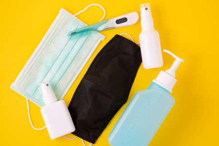 Doctor Mask ,cloth mask and N95 for wearing germ protection Coronavirus or covid 19 and gel alcohol or hand sanitizer bottle for washing hand, fever monitor for doctor hospitals on yellow background.の写真素材