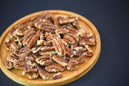Cashews Nut or cashewkerne nuts group Protein and healthy food for diet in a wooden plate on a black background.の写真素材