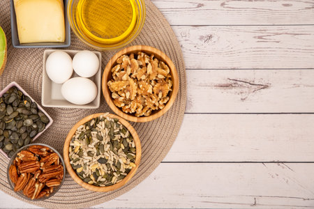 Group Nuts on the bowl and fruit is banana,pineapple and grape is food healthy on the wooden table backgroundの写真素材