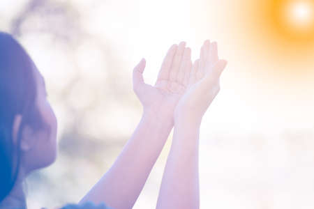 woman praying and worship to GOD Using hands to pray in religious beliefs and worship christian in the church or in general locations in vintage color tone or copy space.の写真素材