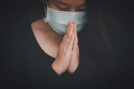 woman praying and worship to GOD Using hands to pray in religious beliefs and worship christian in the church or in general locations in vintage color tone.の写真素材