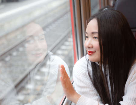 An Asian woman and her family are enjoying a winter snowy vacation and doing family activities in Zermatt Matterhorn in Switzerland.の写真素材