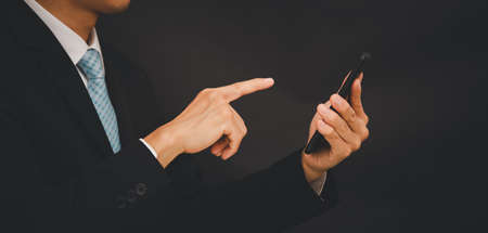 Businessman Touching in graph Screen Icon of a media screen, Technology Process System Business concept.の写真素材