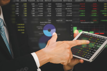 Businessman touchscreen tablet on the graph Screen Icon of stock market ,Technology Process System...