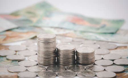 Coins with credit card and  bank notes on the white background for finance and banking , Saving ideas and investment budget, Creative ideas concept of saving moneyの写真素材