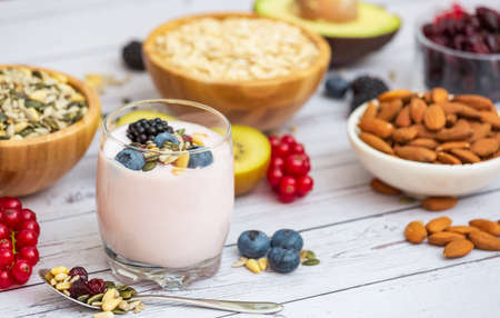 Group Fruits Breakfast with bread Whole grains and nuts, yogurt mix with Cherry , banana, avocado in the wooden table. Breakfast for Health and Diet conceptの写真素材