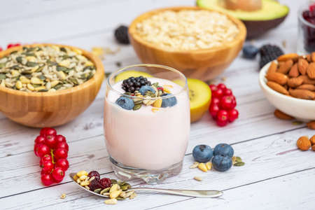 Group Fruits Breakfast with bread Whole grains and nuts, yogurt mix with Cherry , banana, avocado in the wooden table. Breakfast for Health and Diet conceptの写真素材