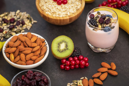 Fruits and Breakfast with Whole grains and nuts, yogurt mix with Cherry , banana, avocado in the wooden table. Breakfast for Health and Diet conceptの写真素材