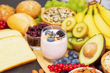Group Fruits Breakfast with bread Whole grains and nuts, yogurt mix with Cherry , banana, avocado in the wooden table. Breakfast for Health and Diet conceptの写真素材