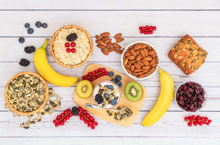 Group Fruits Breakfast with bread Whole grains and nuts, yogurt mix with Cherry , banana, avocado in the wooden table. Breakfast for Health and Diet conceptの写真素材