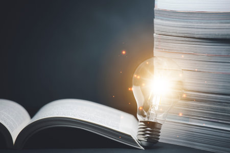 Light bulb and  vintage book style vintage dark background,The idea of reading books, knowledge, and...