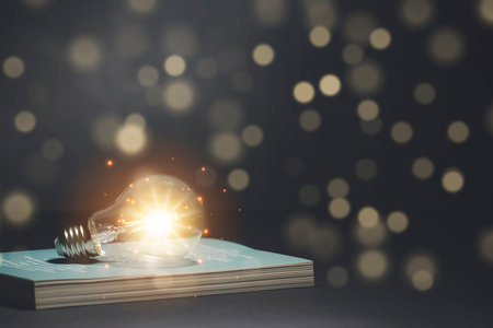 Light bulb and  vintage book style vintage dark background,The idea of reading books, knowledge, and...