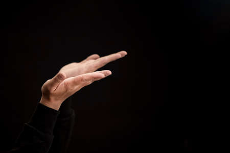 Woman's hand praying and worship to GOD Using hands to pray in religious beliefs and worship christian in the church or in general locations in vintage color tone or copy space.の写真素材