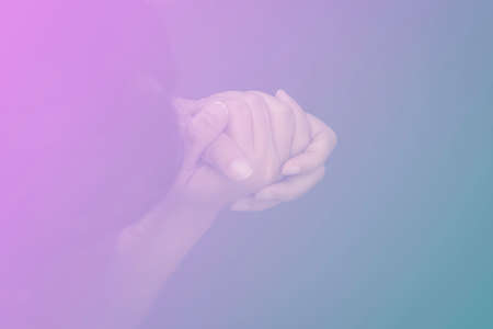 Woman's hand praying and worship to GOD Using hands to pray in religious beliefs and worship christian in the church or in general locations in vintage color tone.の写真素材