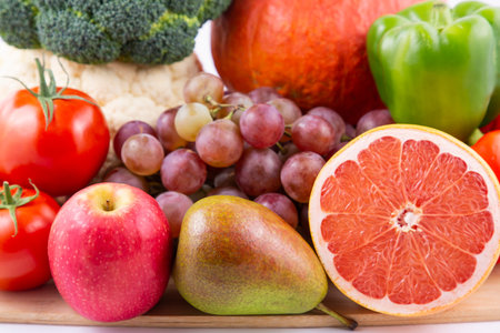 Group vegetables and Fruits Apples, grapes, oranges, and bananas in the wooden basket with carrots,...
