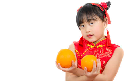 A picture of an Asian girl wearing a red Chinese dress in a white background. Concept Chinese new year for the love day and is a tradition in China every year.の写真素材