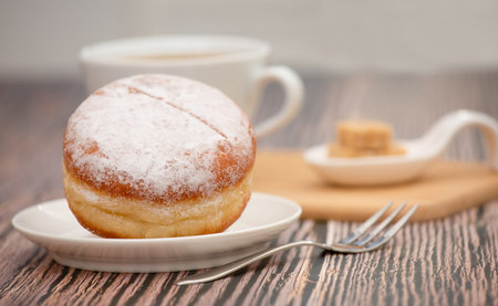 Dessert, Donuts, chocolate and strawberry circles, sugar and cream on Donuts and hot coffee cups, preparation for a break or party on the wooden table background.の写真素材