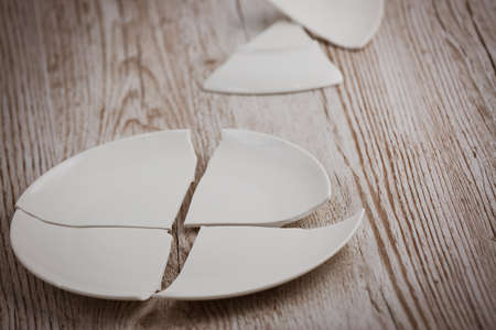 Broken Plate  on the floor in the kitchen The concept of accidents in the kitchen is dangerous for the body and young children inside the house.の写真素材