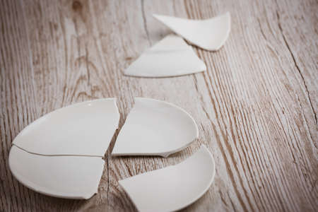 Broken Plate  on the floor in the kitchen The concept of accidents in the kitchen is dangerous for the body and young children inside the house.の写真素材