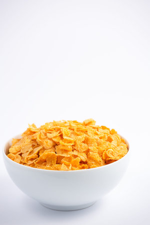 Natural corn flake breakfast cereal in cups and milk is a healthy breakfast that is good for your...