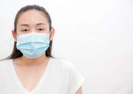 The image face of a young Asian woman and family wearing mask to prevent germs, toxic fumes, and dust. Prevention of bacterial infection in the air in a white backgroundの写真素材