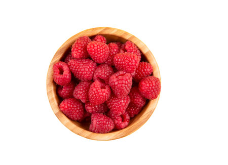Raspberries and blueberries of nature fruit in the wood bowl, healthy food for diet.