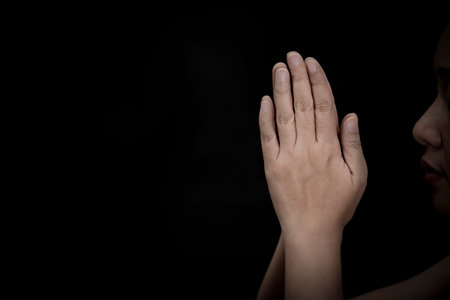 Woman's hand praying and worship to GOD Using hands to pray in religious beliefs and worship...