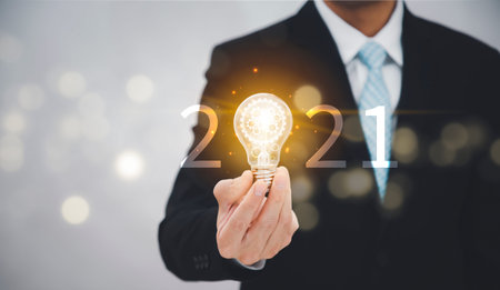 New Target business and 2021 light bulb concept, Business holding light bulb, innovative idea of ââinspiration from online technology, Changes in new planning, Business growth, ideas and perspectives.の写真素材