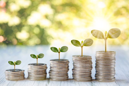 Coins stack and leaf with  line graph  business connect on nature background, Saving  ideas and ...