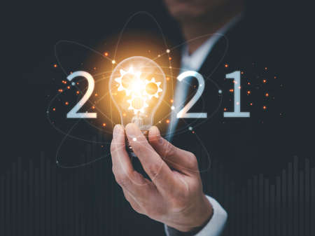 New Target business and 2021 light bulb concept, Business holding light bulb, innovative idea of ââinspiration from online technology, Changes in new planning, Business growth, ideas and perspectives.の写真素材