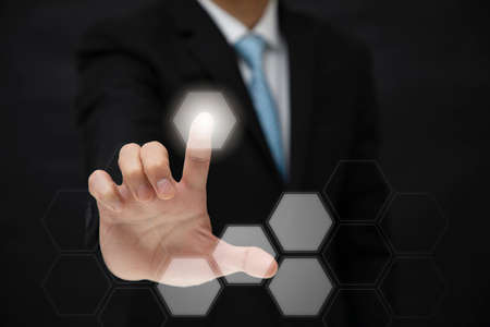 Businessman Touching in graph Screen Icon of a media screen, Technology Process System Business concept.の写真素材