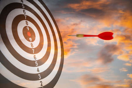 New Target and goal as concept, Close up shot of the dart arrow hit on bullseye, red dart arrow hitting in the target center of dartboard Target hit in the center, challenge in business marketing.の写真素材