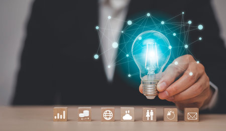 thinking and creative concept, Close up light bulb with business icon and working on desk, Creativity and innovation are keys to success.Concept of new idea and innovation with Brain and light bulbsの写真素材
