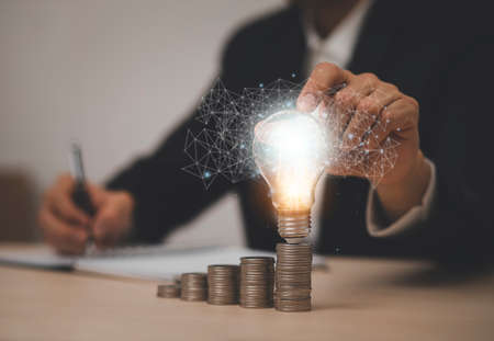 thinking and creative concept, Close up light bulb and working on the desk, Creativity and innovation are keys to success.Concept of new idea and innovation with Brain and light bulbs, working at homeの写真素材