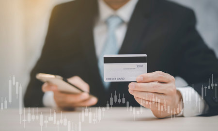 Businessman holding credit card for makes a purchase on the Internet on the laptop computer with...
