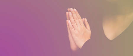 Woman's hand praying and worship to GOD Using hands to pray in religious beliefs and worship christian in the church or in general locations in vintage color tone or copy space.の写真素材