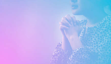 Woman's hand praying and worship to GOD Using hands to pray in religious beliefs and worship christian in the church or in general locations in vintage color tone or copy space.の写真素材