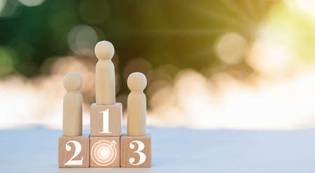 Winners figures on pedestal and losers on floor, Business hierarchy, ranking, strategy concept with wood doll standing on podium 1, 2, 3 of wooden building blocks, Champions podium mockup, copy spaceの写真素材