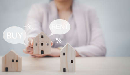 Mini wood house model from model on wood table and word BUY or Rent , Planning buy Real Estate, Planning to buy property. concept of Choose the best and new home for Family,の写真素材
