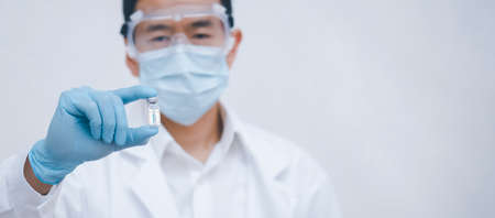 Asian doctor or scientist with a stethoscope holding  vaccine, Healthcare And Medical concept, vaccine Concept fight against virus  virusの写真素材