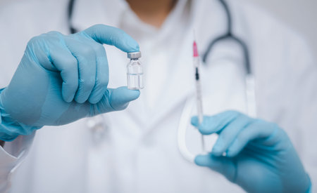 Doctor or scientist with a stethoscope holding  vaccine, measles, vaccine shot for diseases outbreak vaccination, vaccine Concept fight against virus  virusの写真素材