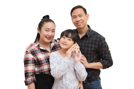 family Asian happy hand holding mini wood house model from model on wood table, Planning buy Real Estate, Planning to buy property. concept of Choose the best.の写真素材