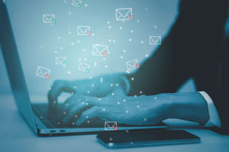 Email concept with laptop spam and virus computer monitor internet security concept, businessman reading electronic mail with a laptop. Spam, junk and e-marketing on screen, Spam Email Pop-up Warning.の写真素材