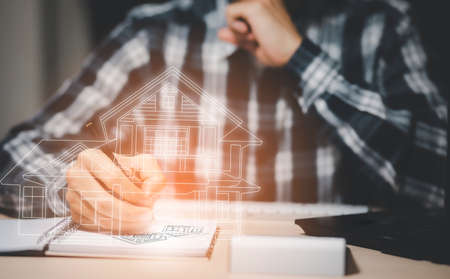 engineering and architecture drawings concept, Engineer man writing of architect starting draw a house blueprint on the desk in the home office, work from homeの写真素材
