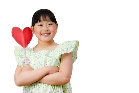 Happy Asian little girl smiling Holding a red paper heart isolated over in the white background, Health care, Copy space, save the Clipping path.の写真素材