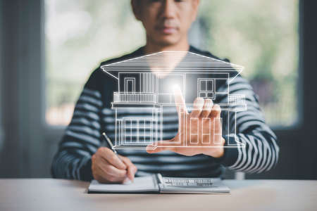 engineering and architecture drawings concept, Engineer man writing of architect starting draw a house blueprint on the desk in the home office, work from homeの写真素材