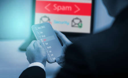 Email concept with laptop spam and virus computer monitor internet security concept, businessman reading electronic mail with a laptop. Spam, junk and e-marketing on screen, Spam Email Pop-up Warning.の写真素材