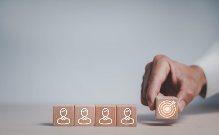 Businessman hand holding wood cubes with bullseye target icon, HR Human and people icon,Technology Process System Business with Recruitment, Hiring, Team Building.Organisation structure concept.の写真素材